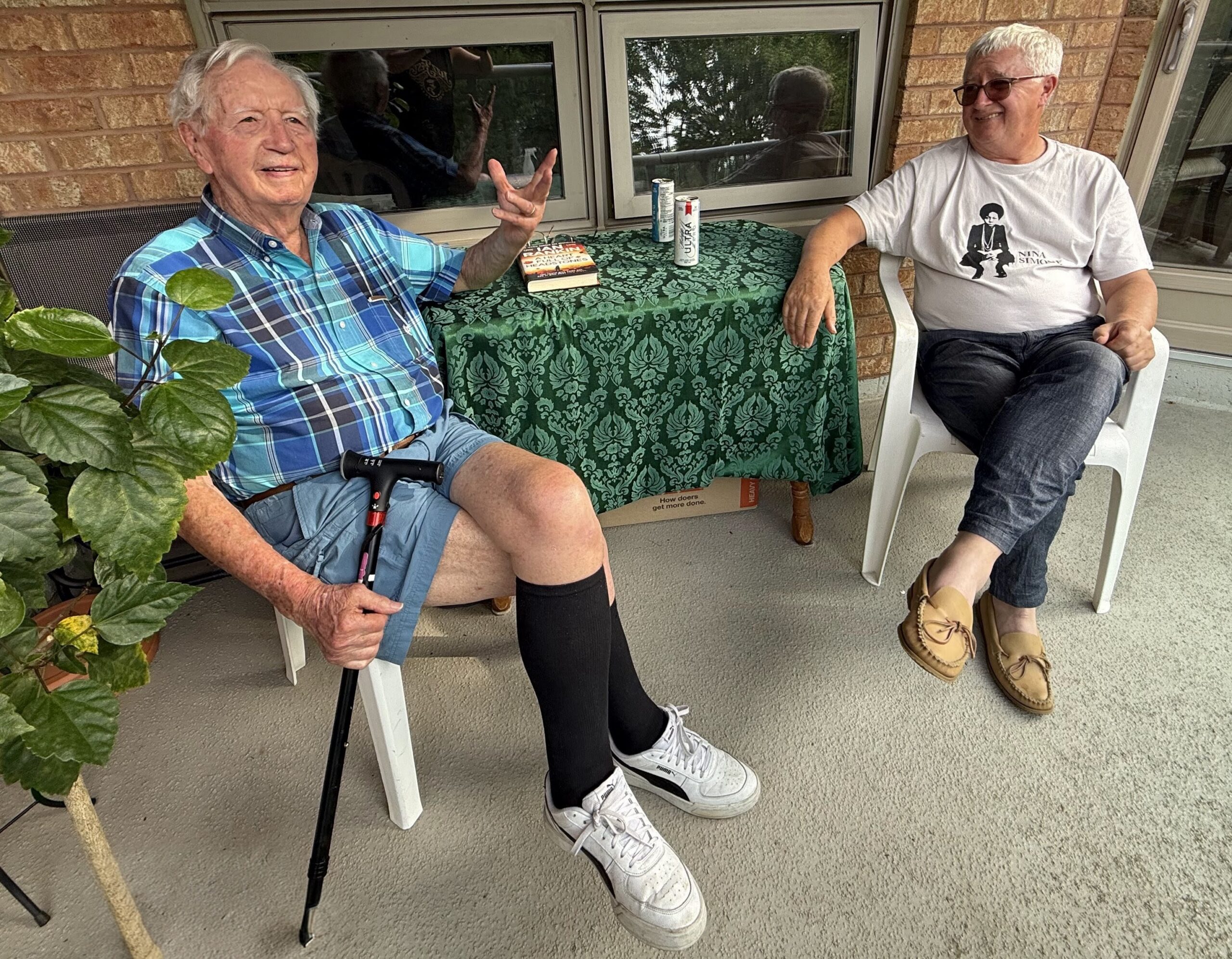Bill and MAO sharing a conversation on the balcony, June 2026